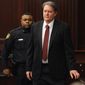FILE - Defendant Michael Dunn is brought into the courtroom in this Feb. 15, 2014 file photo where Judge Russell Healey announced that the jury was deadlocked on charge one and have verdicts on the other four charges as they deliberate in the trial of Dunn, for the shooting death of Jordan Davis in November 2012. A motion filed Tuesday March 3, 2014 by Assistant State Attorney John Guy says Florida law doesn’t allow for a delay in sentencing when a defendant faces additional charges. (AP Photo/The Florida Times-Union, Bob Mack, File)