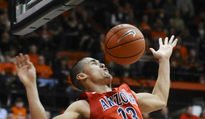 Arizona&#x27;s Nick Johnson (13) scores against Oregon State during the first half of an NCAA college basketball game in Corvallis, Ore., Wednesday March 5, 2014.  (AP Photo/Greg Wahl-Stephens)