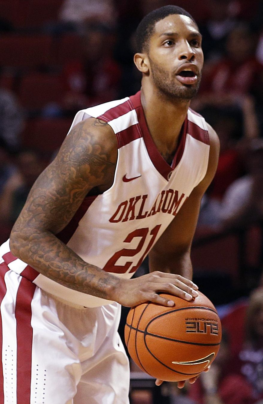 Oklahoma's Cameron Clark (21) takes a shot during an NCAA game between Oklahoma and West Virginia at the Lloyd Noble Center in Norman, Okla., Wednesday, March 5, 2014. (AP Photo/Garett Fisbeck)