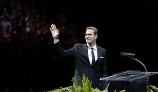 Former Detroit Red Wing Nicklas Lidstrom waves to the crowd during the retirement ceremony for his No. 5 before an NHL hockey game between the Detroit Red Wings and Colorado Avalanche at Joe Louis Arena, Thursday, March 6, 2014, in Detroit. (AP Photo/Duane Burleson)