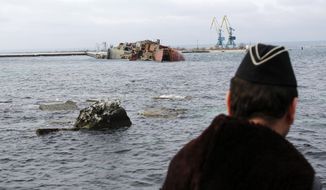 A Ukrainian Navy officer looks at the scuttled decommissioned Russian vessel &amp;quot;Ochakov&amp;quot; from the Black Sea shore outside the town of Myrnyi, western Crimea, Ukraine, Thursday, March 6, 2014.  In the early hours of Thursday Russian naval personnel scuttled the decommissioned ship, blockading access for five Ukrainian Naval vessels now trapped inside of the Southern Naval Headquarters located in Myrnyi in Western Crimea as Russian war vessels patrolled just of the coast. The vessel was brought by Russian naval forces on the 4th of March towed by a tug boat while escorted by a warship and several gun boats.  Marines from the Ukrainian navy heard a loud explosion in the early hours of last night coming from the vessel blocking a channel leading to the Black Sea.  (AP Photo/Darko Vojinovic)