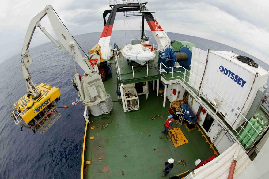 ADDS INFO: OFF THE COAST OF GEORGIA - In this 2003 photo provided by Odyssey Marine Exploration, the company’s eight-ton remotely operated vehicle, named Zeus, is launched for a descent to the ocean floor from the ship Odyssey Explorer about 100 miles off the coast of Georgia. Under a deal, approved by Judge Patrick Sheeran of the Franklin County Court of Common Pleas in Columbus, Ohio, on Wednesday, March 5, 2014, the Tampa, Fla.-based company can begin working to recover gold bars and coins from the wreck of the SS Central America next month. (AP Photo/Odyssey Marine Exploration)