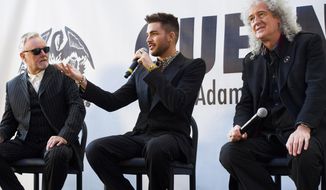 From left, Roger Taylor,, Adam Lambert and Brian May announce a Queen + Adam Lambert summer tour, on Thursday, March 6, 2014 in New York. (Photo by Charles Sykes/Invision/AP)