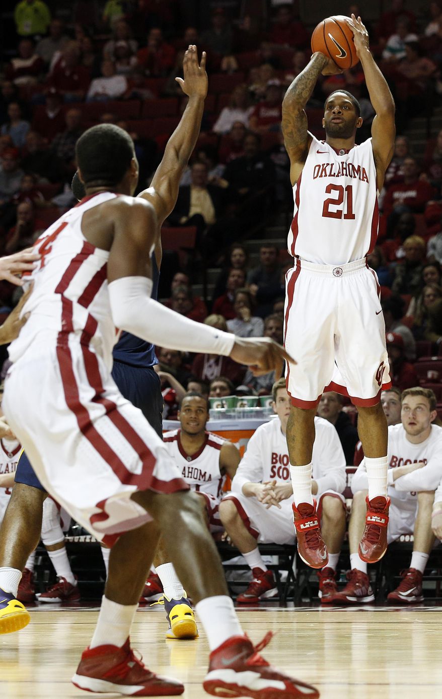 Oklahoma's Cameron Clark (21) takes a shot during an NCAA college basketball game against West Virginia in Norman, Okla., Wednesday, March 5, 2014. (AP Photo/Garett Fisbeck)