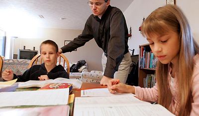 In this March 13, 2009 file photo Uwe Romeike works with two of his children Josua (9 yrs.) and Lydia (10 yrs.) at their home in Morristown, Tenn.  (AP Photo/Wade Payne)