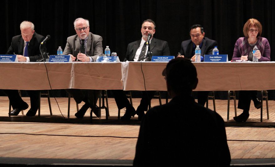 A panel of officials with the U.S. Department of Energy and the Waste Isolation Pilot Plant take questions from a community member during a town hall in Carlsbad, N.M. on Thursday, March 6, 2014. Operations at the underground nuclear waste repository were halted in February following a truck fire and a release of radiation nine days later. (AP Photo/Susan Montoya Bryan)