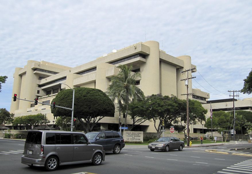 Cars pass in front of the federal building housing U.S. District Court in Honolulu on Friday, March 7, 2014. A courtroom in this building is set to become the scene of a death penalty trial even though Hawaii abolished capital punishment in 1957. (AP Photo/Jennifer Sinco Kelleher)