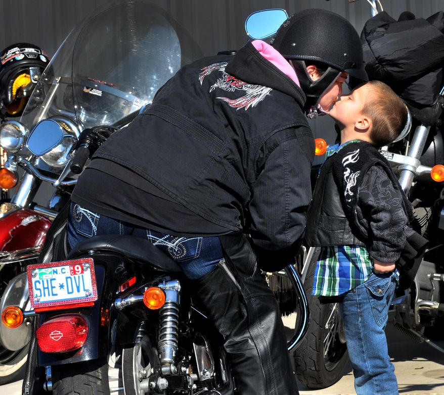 Zane Goodwin, 4, runs over to give a kiss to Wendy James as she arrived at the Freedom Biker Church Sunday, Feb. 16, 2014. (AP Photo/The Fayetteville Observer, Cindy Burnham.)
