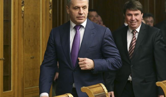 Crimea&#x27;s prime minister Sergei Aksyonov, center, enters a hall prior the talks in Russian Parliament in Moscow, Russia, Friday, March 7, 2014. Valentina Matvienko, speaker for Russia&#x27;s upper house of parliament says Crimea would be welcome as an &amp;quot;equal subject&amp;quot; in Russia if the region votes to leave Ukraine in an upcoming referendum. Russia&#x27;s parliament is planning to review a bill as early as next week that would speed up Crimea&#x27;s integration into Russia. Crimea would be the first territory to officially join Russia since the breakup of the Soviet Union in 1991. (AP Photo/Alexander Shalgin)