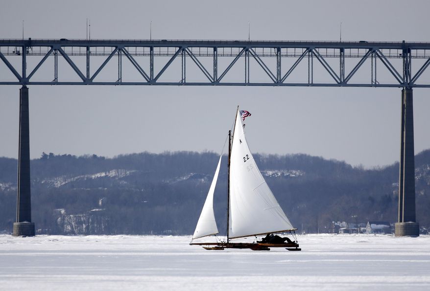 An ice boat sails along the Hudson River near the Kingston-Rhinecliff Bridge on Saturday, March 1, 2014, in Barrytown, N.Y. More than a dozen boats hit the ice last weekend on a wide stretch of the river about 100 miles north of New York City. (AP Photo/Mike Groll)