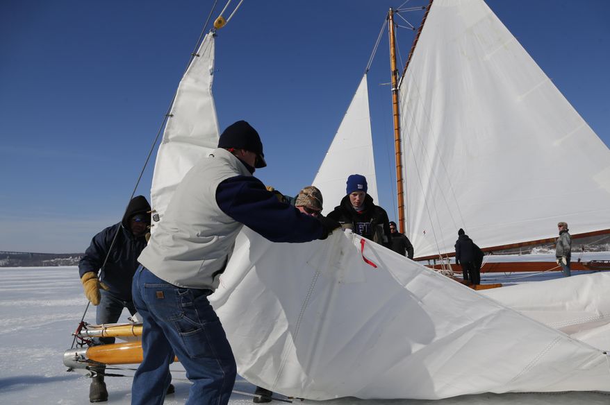 The sail of the ice boat Rocket is raised on the Hudson River on Saturday, March 1, 2014, in Barrytown, N.Y. More than a dozen boats hit the ice last weekend on a wide stretch of the river about 100 miles north of New York City. (AP Photo/Mike Groll)