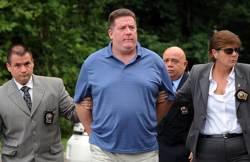 FILE - This Aug. 15, 2012 photo shows Raymond Roth, center, as he is escorted by law enforcement officers to the Long Island State Park Police Headquarters, in Babylon, N.Y. Roth already facing prison time for faking his own drowning in an insurance fraud scheme was convicted Friday, March 7, 2014 of impersonating a police officer, but he was cleared of attempting to kidnap a woman authorities said he chased and tried to force into his van. (AP Photo/Kathy Kmonicek, File)