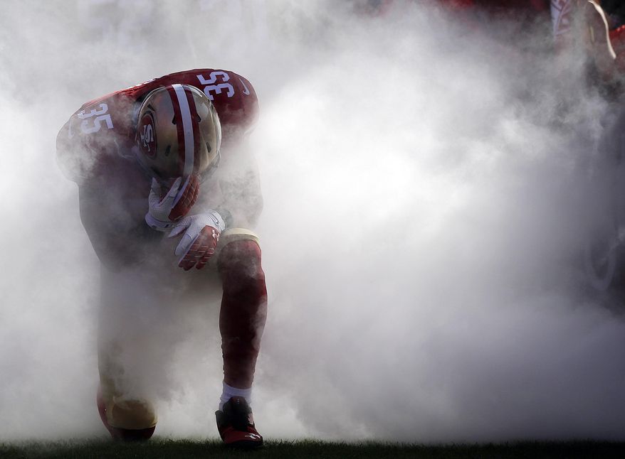 FILE - In this Nov. 10, 2013, file photo, San Francisco 49ers safety Eric Reid (35) is introduced before an NFL football game against the Carolina Panthers in San Francisco. The photo was honored by the Associated Press Sports Editors as best sports feature photo of 2013 at their annual winter meeting in Indianapolis. (AP Photo/Marcio Jose Sanchez, File)