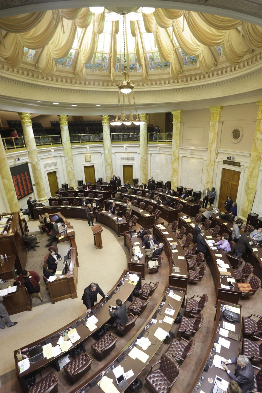 in theA few legislators remain during a recess in a near-empty House chamber at the Arkansas state Capitol in Little Rock, Ark., Friday, March 7, 2014. Earlier Friday legislators in the Joint Budget Committee endorsed a $5 billion budget bill that boosts funding for public schools and prisons. (AP Photo/Danny Johnston)