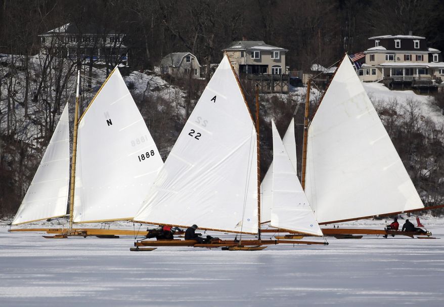 Ice boats sail along the Hudson River on Saturday, March 1, 2014, in Barrytown, N.Y. More than a dozen boats hit the ice last weekend on a wide stretch of the river about 100 miles north of New York City. (AP Photo/Mike Groll)