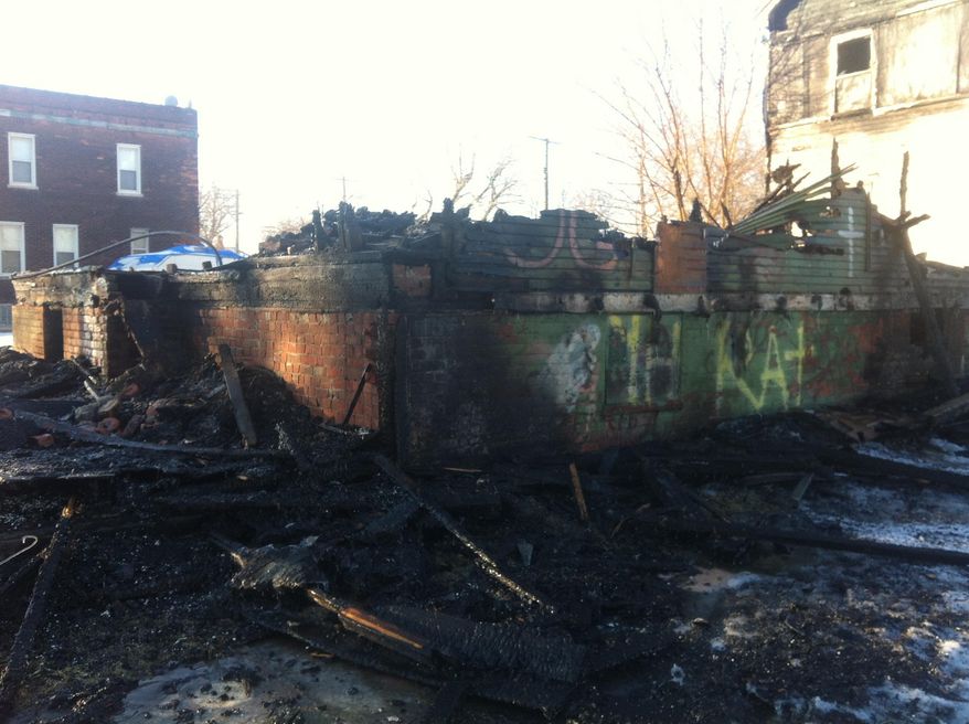 This Friday, March 7, 2014 photo shows the remnants of a house that was part of the Heidelberg Project outdoor art installation in Detroit was destroyed by fire. The home was known as the "Party Animal" house or "Doll House." The Heidelberg Project has been the target of at least eight suspicious fires since May. (AP Photo, Mike Householder)