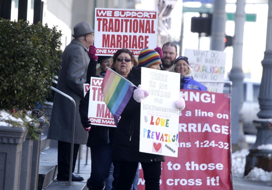 Supporters and protesters chant before closing arguments in the trial of two Detroit-area nurses, Jayne Rowse and April DeBoer, challenging Michigan's gay-marriage ban at the Theodore Levin Federal Court in Detroit Friday March 7, 2014. Michigan's ban on same-sex marriage was approved by voters in 2004. Detroit federal Judge Bernard Friedman is not expected to make a decision Friday. (AP Photo/Detroit Free Press, Mandi Wright) DETROIT NEWS OUT; NO SALES