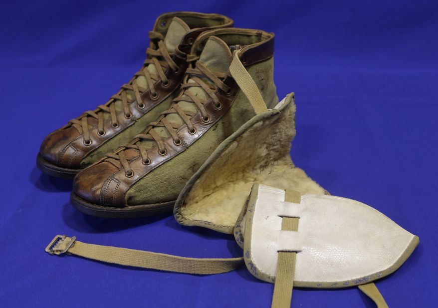 In this Feb. 19, 2014 photo, a pair of vintage leather and canvas basketball shoes and a set of knee pads are shown as part of an exhibit entitled "The Black Fives," at the New-York Historical Society in New York. Dozens of teams flourished between 1904 and 1950 in what became known as the Black Fives Era, an often-overlooked piece of black history that is the subject of an exhibition opening at the New-York Historical Society on March 14. (AP Photo/Frank Franklin II)