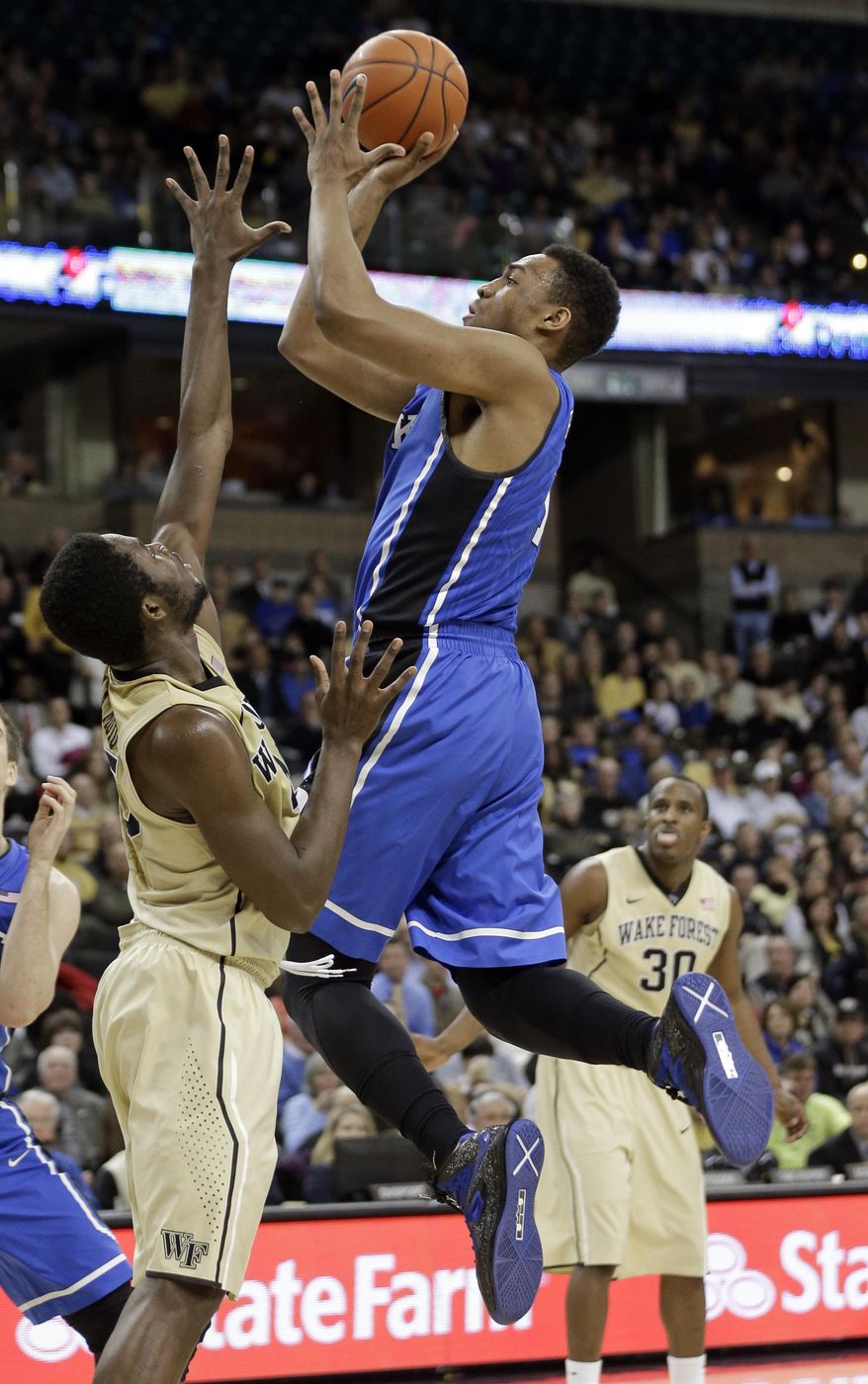Duke's Jabari Parker, right, shoots over Wake Forest's Arnaud-William Adala Moto, left, during the second half of an NCAA college basketball game in Winston-Salem, N.C., Wednesday, March 5, 2014. Wake Forest won 82-72. (AP Photo/Chuck Burton)