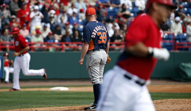 Houston Astros starting pitcher Brett Oberholtzer (39) watches as members of the Washington Nationals round the bases during Wilson Ramos&#x27; three-run homer in the first inning of a spring exhibition baseball game, Friday, March 7, 2014, in Viera, Fla. (AP Photo/Alex Brandon)