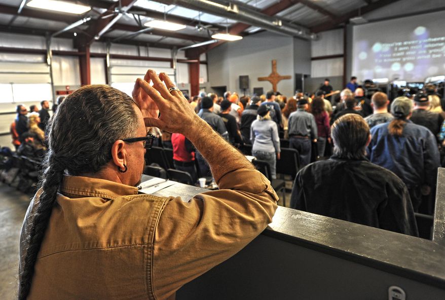 JD Tew, pastor at the Freedom Biker Church, listens to the band "When Forever Comes," before he speaks Sunday, Feb. 16, 2014. (AP Photo/The Fayetteville Observer, Cindy Burnham.)