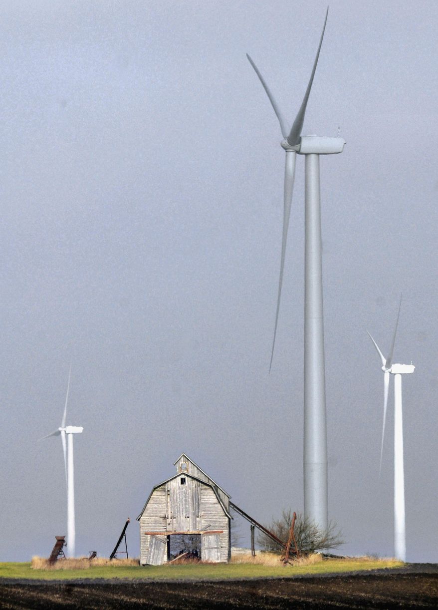 FILE - In this Nov. 23, 2011 file photo, several wind turbines are seen east of Paxton, Ill. A new report released Friday, March 7, 2014, by national and state environmental groups, including the World Wildlife Fund and the Chicago-based Environmental Law & Policy Center, says Illinois leads the nation when it comes to switching to renewable energy. (AP Photo/The News-Gazette, Robin Scholz, File) MANDATORY CREDIT