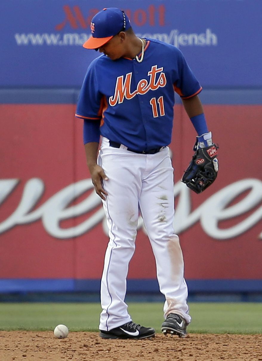 New York Mets shortstop Ruben Tejada looks down after misplaying a ball hit by St. Louis Cardinals' Tony Cruz during the fourth inning of an exhibition spring training baseball game on Friday, March 7, 2014, in Port St. Lucie, Fla. Cruz reached first and Tejada was charged with an error on the play. (AP Photo/Jeff Roberson)