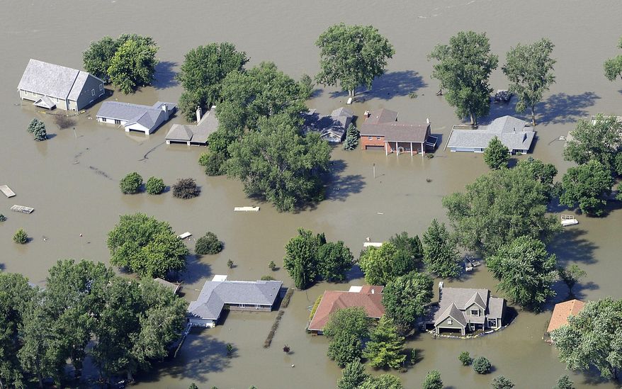 FILE - This June 29, 2011 aerial file photo shows homes inundated by Missouri River floodwaters in Union County, S.D. Jody Farhat, an official with the Corps of Engineers says the mountain snowpack in the Missouri River's upper basin is close to levels seen before 2011 flooding on the river. But she says flooding this year is still far less likely because drought in 2012 has resulted in a one-third increase in water storage capacity in the three Missouri River reservoirs in the Dakotas and Montana. (AP Photo/The Sioux City Journal, Tim Hynds, File) NO SALES