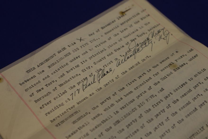 In this Feb. 19, 2014 photo, a professional basketball contract between the New York Renaissance and James Usry is shown as part of an exhibit entitled "The Black Fives," at the New-York Historical Society in New York. Dozens of teams flourished between 1904 and 1950 in what became known as the Black Fives Era, an often-overlooked piece of black history that is the subject of an exhibition opening at the New-York Historical Society on March 14. (AP Photo/Frank Franklin II)