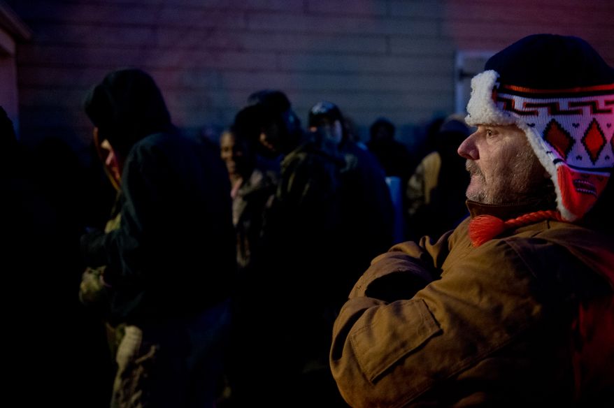 A crowd gathers in the cold pre-dawn hours to be let into the Remote Area Medical's facilities to be seen by a doctor at Southern Virginia University, Buena Vista, Va., Saturday, March 1, 2014. Remote Area Medical Volunteer Corps (RAM) is a Knoxville, Tennessee-based, non-profit, volunteer, airborne medical relief corps that provides free health care, dental care, eye care, veterinary services, and technical and educational assistance to people in remote areas of the United States, and around the world for people that need it. (Andrew Harnik/The Washington Times)