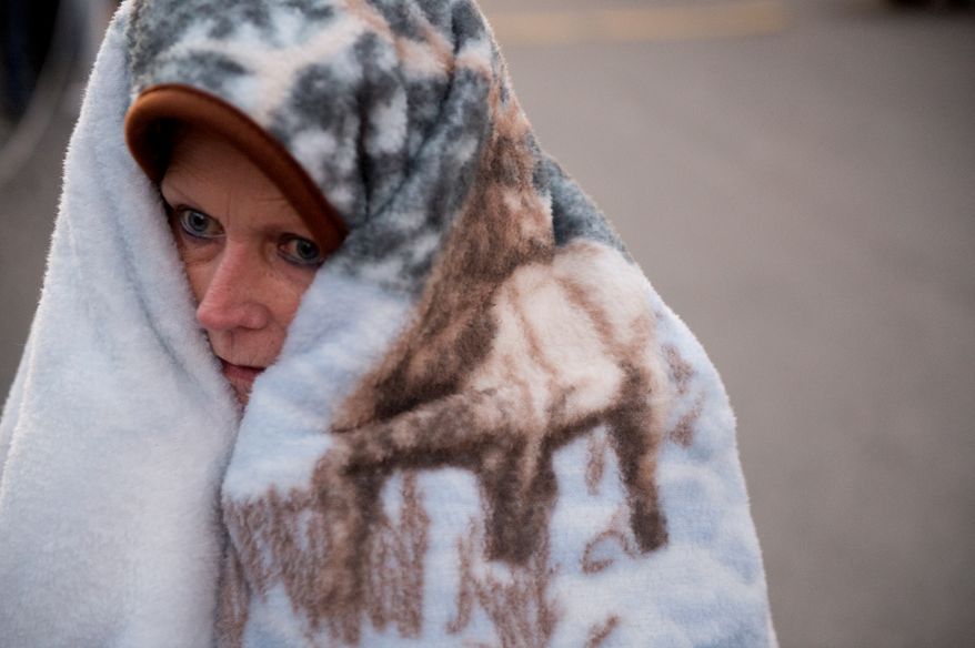 Donna Thomas of Natural Bridge, Va. tries to stay warm the cold pre-dawn hours as she waits to be let into the Remote Area Medical's facilities to be seen by a doctor at Southern Virginia University, Buena Vista, Va., Saturday, March 1, 2014. Remote Area Medical Volunteer Corps (RAM) is a Knoxville, Tennessee-based, non-profit, volunteer, airborne medical relief corps that provides free health care, dental care, eye care, veterinary services, and technical and educational assistance to people in remote areas of the United States, and around the world for people that need it. (Andrew Harnik/The Washington Times)