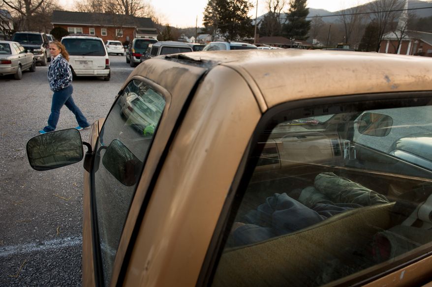 A man sleeps in his car in the cold early morning hours as he waits to be let into the Remote Area Medical's facilities to be seen by a doctor at Southern Virginia University, Buena Vista, Va., Saturday, March 1, 2014. Remote Area Medical Volunteer Corps (RAM) is a Knoxville, Tennessee-based, non-profit, volunteer, airborne medical relief corps that provides free health care, dental care, eye care, veterinary services, and technical and educational assistance to people in remote areas of the United States, and around the world for people that need it. (Andrew Harnik/The Washington Times)