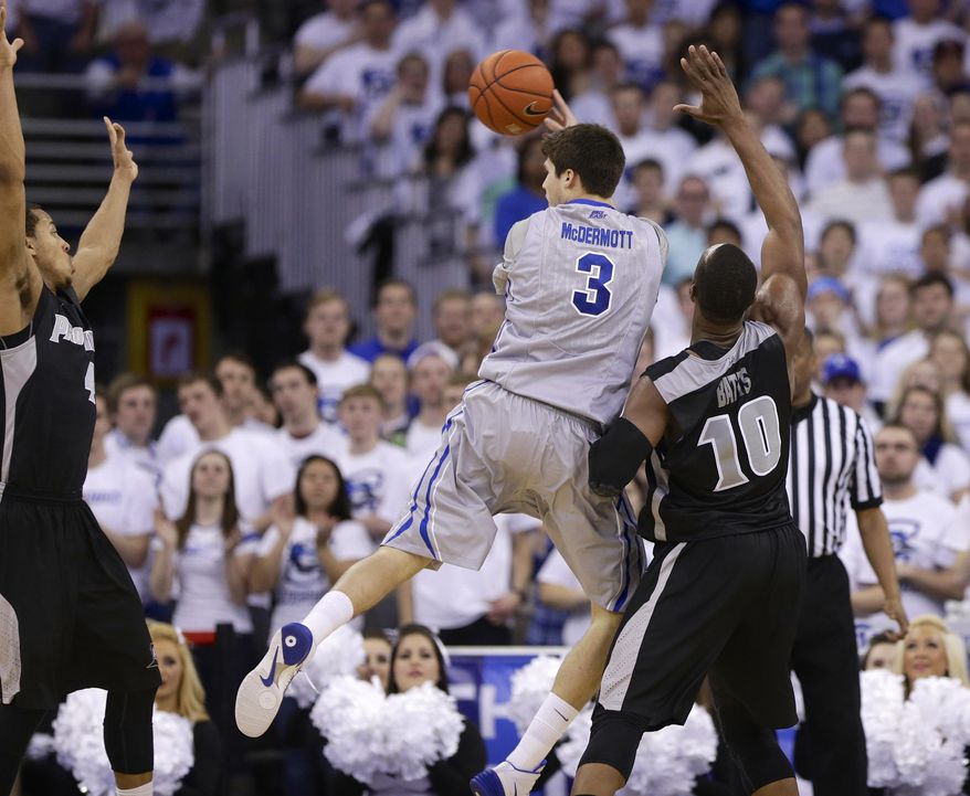 Creighton's Doug McDermott (3) passes the ball against the defense of Providence's Kadeem Batts (10) and Providence's Josh Fortune, left, in the first half on an NCAA college basketball game in Omaha, Neb., Saturday, March 8, 2014. (AP Photo/Nati Harnik)