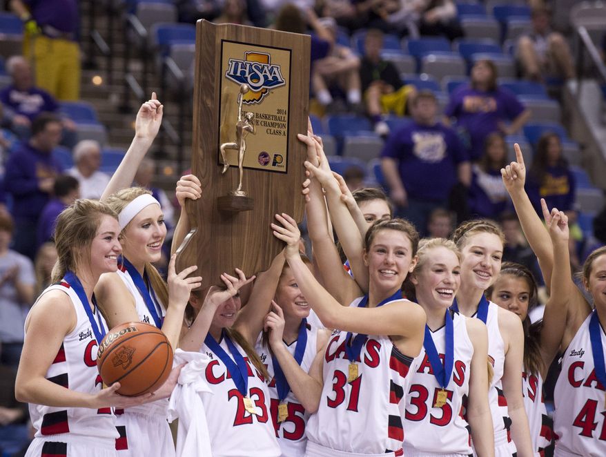 Oregon-Davis High School players celebrate with their trophy after winning the IHSAA Girls Basketball Class A Championships, March 8, 2014, in Terre Haute, Ind. Oregon-Davis defeated Vincennes Rivet 69-64. (AP Photo/Doug McSchooler)