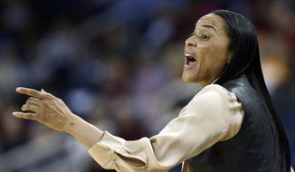 South Carolina  head coach Dawn Staley directs her team from the sideline in the second half of an NCAA college basketball game against Kentucky in the semifinals of the Southeastern Conference women&#x27;s basketball tournament Saturday, March 8, 2014, in Duluth, Ga. (AP Photo/John Bazemore)