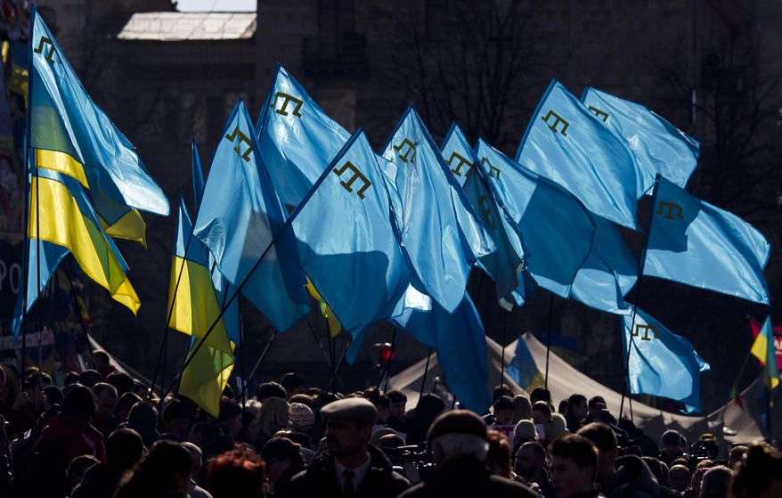 Demonstrators hold Ukrainian and Crimean Tatar flags during a protest in support of Crimean Tatars in Kiev's Independence Square, Ukraine, Saturday, March 8, 2014. As Crimea's parliament proceeds with plans for a referendum on the peninsula's future, the area's largest ethnic minority, the Tatars, feel increasingly threatened. (AP Photo/David Azia)