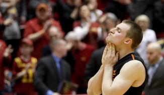 Oklahoma State guard Phil Forte III walks to the bench after their 85-81 loss in overtime against Iowa State in an NCAA college basketball game in Ames, Iowa, Saturday, March 8, 2014. (AP Photo/Justin Hayworth)