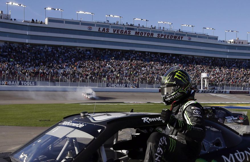 Kyle Busch exits his car after finishing second to Brad Keselowski, doing a burnout at rear, in the NASCAR Nationwide Series auto race Saturday, March 8, 2014, in Las Vegas. (AP Photo/Isaac Brekken)