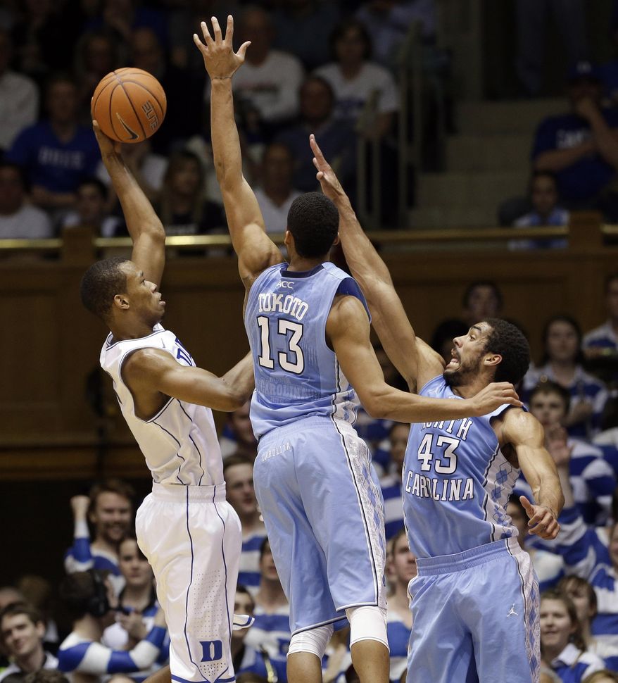 Duke's Rodney Hood, left, shoots as North Carolina's J.P. Tokoto (13) and James Michael McAdoo (43) defend during the first half of an NCAA college basketball game in Durham, N.C., Saturday, March 8, 2014. (AP Photo/Gerry Broome)