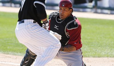 Arizona Diamondbacks catcher Henry Blanco tags out Chicago White Sox's Carlos Sanchez attempting to steal home plate in the third inning during an exhibition baseball game in Glendale, Ariz., Saturday, March 8, 2014. (AP Photo/Paul Sancya)