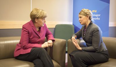 In this picture provided by the German government German Chancellor Angela Merkel, left, meets with Ukrainian politician Yulia Tymoshenko. right, on the occasion of a meeting of the European peoples parties in Dublin, Ireland, Friday, March 7, 2014. (AP Photo/German Government/Guido Bergmann)