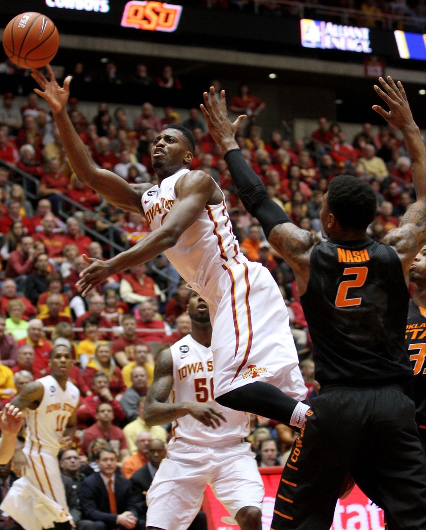 Iowa State forward Melvin Ejim puts up an off blanace shot over Oklahoma State guard/forward Le'Bryan Nash (2) during the second half of an NCAA college basketball game in Ames, Iowa, Saturday, March 8, 2014. (AP Photo/Justin Hayworth)