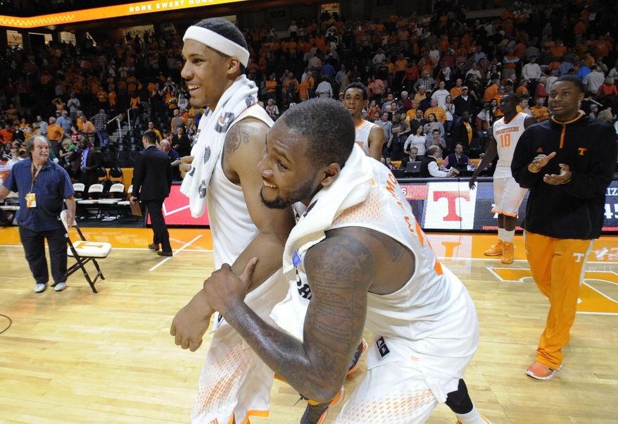 Tennessee forward Jeronne Maymon, right, grabs forward Jarnell Stokes in celebration while heading to the locker room after Tennessee defeated Missouri 72-45 in an NCAA basketball game at Thompson-Boling Arena in Knoxville, Tenn. on Saturday, March 8, 2014. (AP Photo/Knoxville News Sentinel, Adam Lau)