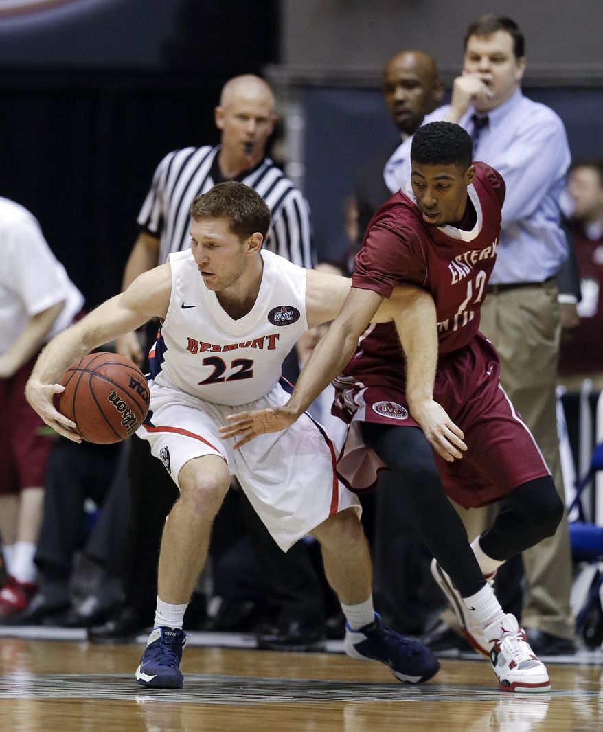 Belmont guard Reece Chamberlain (22) tries to protect the ball from Eastern Kentucky guard Marcus Lewis (12) during the first half of an NCAA college basketball game for the championship of the Ohio Valley Conference men's tournament, Saturday, March 8, 2014, in Nashville, Tenn. (AP Photo/Mark Humphrey)