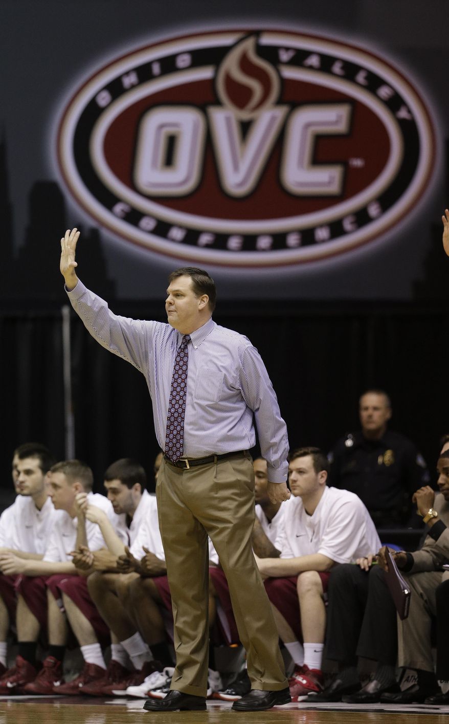 Eastern Kentucky coach Jeff Neubauer signals to his team during the first half of an NCAA college basketball game against Belmont for the championship of the Ohio Valley Conference men's tournament, Saturday, March 8, 2014, in Nashville, Tenn. (AP Photo/Mark Humphrey)