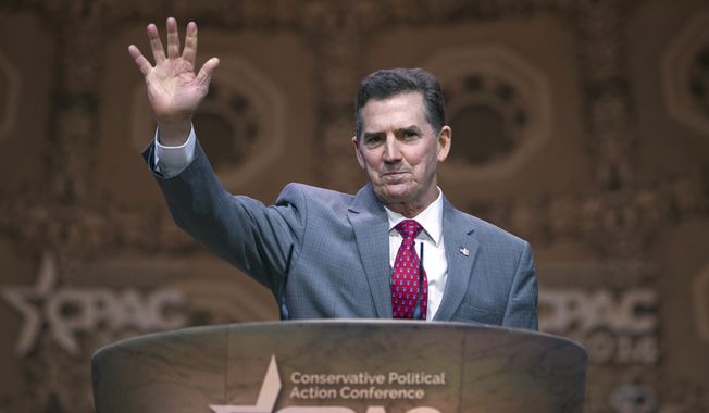 Heritage Foundation President Jim DeMint waves while addressing the Conservative Political Action Conference annual meeting in National Harbor, Md., Saturday, March 8, 2014. Saturday marks the third and final day of the annual Conservative Political Action Conference, which brings together prospective presidential candidates, conservative opinion leaders and tea party activists from coast to coast. (AP Photo/Cliff Owen)
