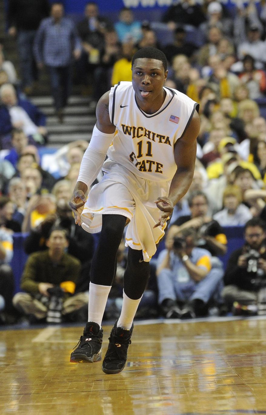 Wichita State's Cleanthony Early (11) celebrates a basket against Missouri State in the first half of an NCAA college basketball game in the semifinals of the Missouri Valley Conference men's tournament, Saturday, March 8, 2014, in St. Louis. (AP Photo/Bill Boyce)