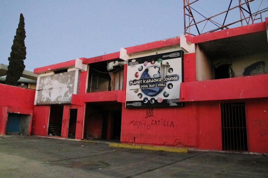 The building that once housed the Planet Music Lounge sits gutted and damaged in Matamoros, Mexico, Friday, Feb. 28, 2014. In the midst of a three-year increase in American tourism in Mexico, communities along the Rio Grande are trying to win back U.S. tourists and revitalize their tourism industry. (AP Photo/Olga Rodriguez)