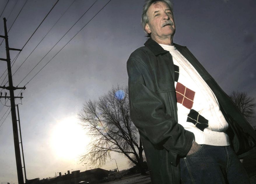 In this photo taken on Feb. 13, 2014, John Wanecke, secretary/treasurer of the North Dakota Renewable Energy Society, poses for a photo in Bismarck, N.D, The non-profit group is launching "Solarize Burleigh County", community-wide purchase campaign to install solar panel on home and businesses. (AP Photo/The Bismarck Tribune, Mike McCleary)