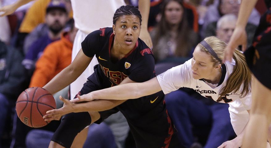 Southern California's Ariya Crook, left, looks for room to pass as Oregon State's Ali Gibson defends in the first half of the Pac-12 NCAA college championship basketball game Sunday, March 9, 2014, in Seattle. (AP Photo/Elaine Thompson)